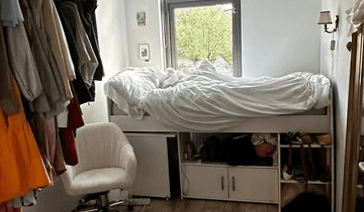 Kaal studentenkamer met gedeelde voorzieningen